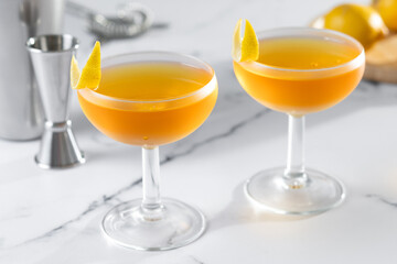Paper plane cocktail on white marble background