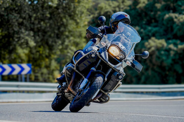 Motorcyclist leaning into curve on touring motorcycle