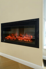 Modern electric fireplace with glowing logs enhancing cozy living room ambiance