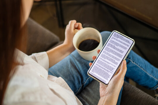 woman hand holding coffee cup and phone, reading text on mobile screen for digital press article feed in the morning. mockup media publication website in smartphone.