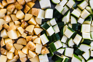 oven tray with cubed baby potatoes and zucchini ready for roasting
