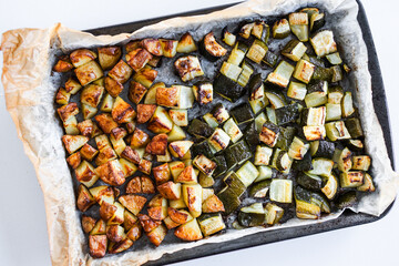 roasted cubed baby potatoes and zucchini on oven tray