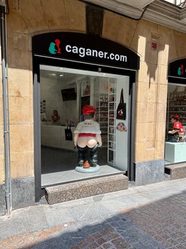 A store dedicated to the Caganer in Bilbao, Spain. The store's interior shows shelves with additional Catalan Caganer figurines and related merchandise. 