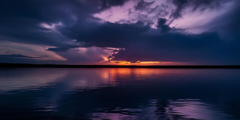 Naklejka premium Dramatic Sunset Over Tranquil Lake with Vibrant Reflections and Cloudy Sky