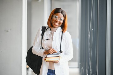 Medical Internship Concept. Portrait Of Young Black Female Doctor Student In White Coat