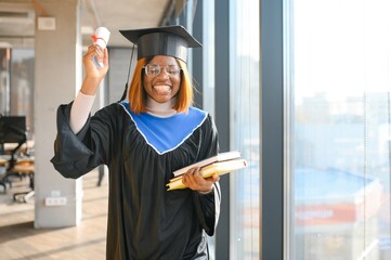 beautiful young afro american graduate holding diploma