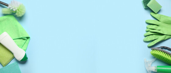 Set of cleaning supplies and bottle of detergent on blue background