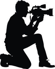 Naklejka premium Silhouette of a kneeling cameraman capturing a moment with a professional camera