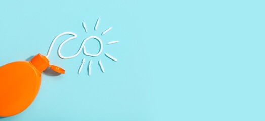 Sunscreen cream and drawn sun on light blue background with space for text