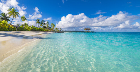 Fototapeta premium Amazing tranquil landscape. Panoramic scene tropical beach paradise in Maldives stunning sea white sand sunny sky luxury resort. Summer holiday destination exotic travel, tourism, relaxation honeymoon