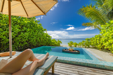 Relaxing sexy woman legs relaxing with floating breakfast in private pool at luxury beach resort....