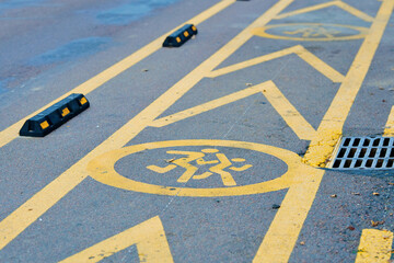 Painted children icon and yellow lines on asphalt indicate secure temporary stopping zone near...