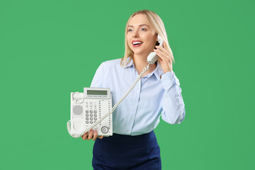 Female secretary with telephone on green background
