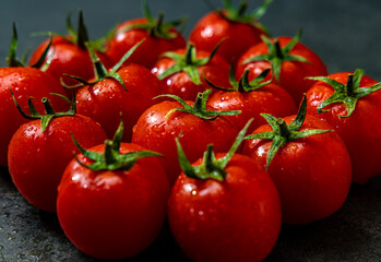 Cherry tomatoes on a dark background isolated close-up