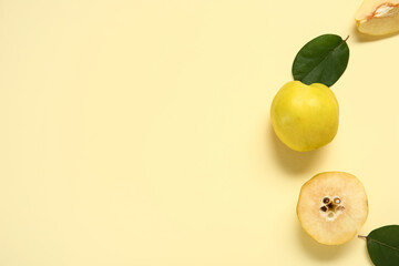 Sweet ripe quinces and leaves on yellow background