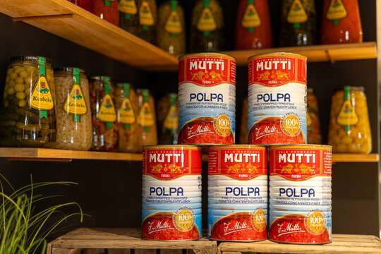 Amsterdam, Netherlands. 5-29-2025. Cans of Mutti Polpa Tomato with Keesbeke Pickles on Wooden Shelves