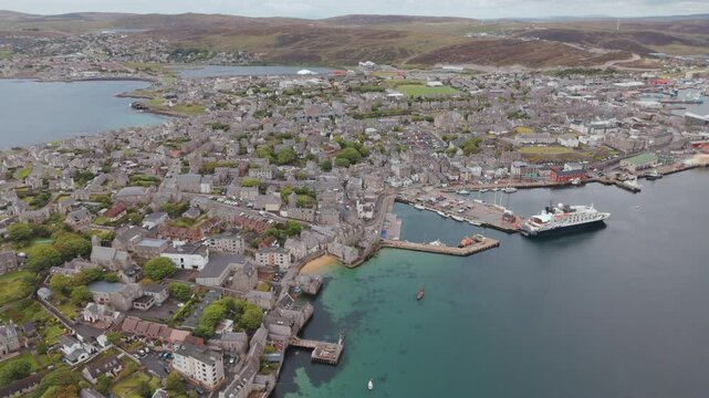 An aerial shot of the seaport town of Lerwick, Shetland in Scotland, sweeping over the port area.