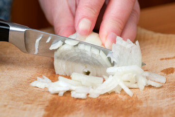 Freshly chopping onions for a delicious home-cooked meal preparation