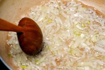 Sizzling onions caramelizing in a pan during a home-cooked meal
