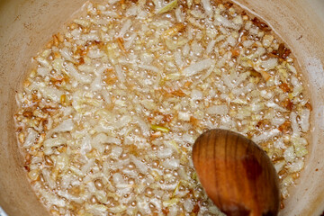 Sizzling onions caramelizing in a pot on a cozy kitchen stove