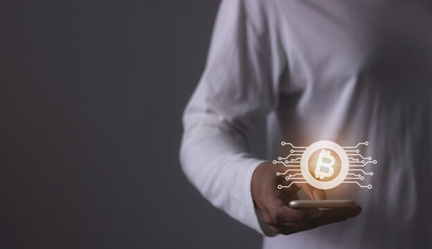 Young man using smartphone hand touching to trade cryptocurrencies online, Investors in cryptocurrencies and bitcoin coins online
