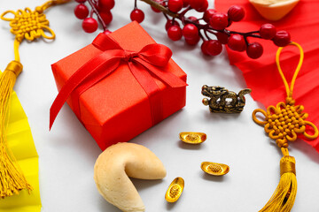 Gift box with fortune cookie, berries and Chinese symbols on white background. New Year celebration