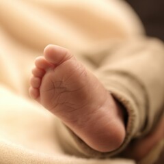 A baby's foot is shown in a close up