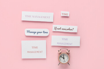 Composition with text Time management and alarm clock on pink background. Top view