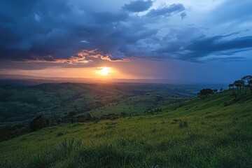 Obraz premium Sunset over a lush valley. Dramatic clouds