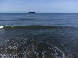 hundreds of surfers waiting for a perfect wave