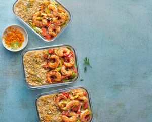 Mediterranean style shrimp with peppers and leeks served with couscous in meal prep containers. 