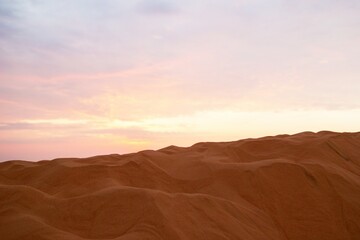 Fototapeta premium Serene Desert Landscape at Sunset Golden Sands and Pastel Skies. Mui Ne, Vietnam.