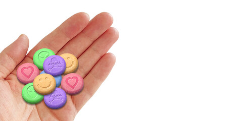 Hand holding a variety of MDMA or Ecstasy pills