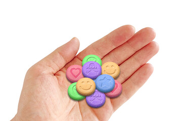 Hand holding a variety of MDMA or Ecstasy pills