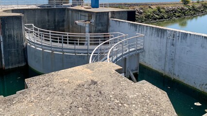 Concrete water locks intersect serenely, evoking hydraulic geometry, environmental engineering...