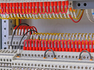 Marking electrical wiring wires with thermally printed nylon tape. 