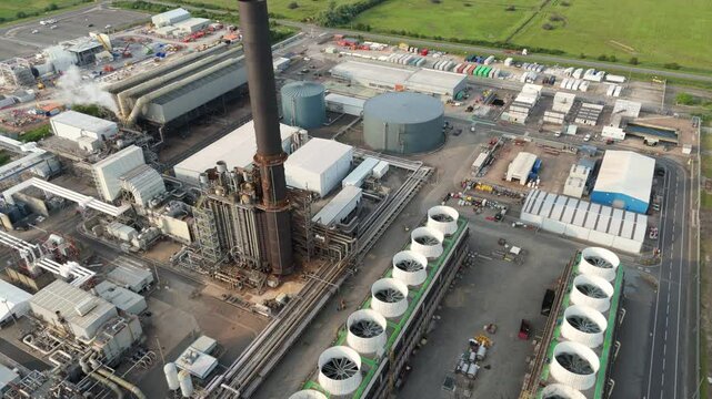 Aerial drone view petrochemical refinery and power plant in Immingham England UK. Smoke stacks, plumes of smoke, industrial piping energy park petrochemical silos.