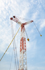 Crane boom. Part of big crane, crawler crane or derrick crane. Machine equipment with hoist, hook and steel truss structure for heavy load lifting in construction industry and assembly work.