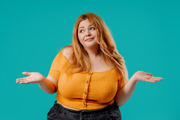 Plus size confused woman shrugging, cant help, makes unsure gesture of dont know
