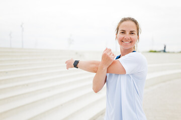 Enjoying a Warm-Up Before an Invigorating Morning Run by the Seaside Under a Cloud-Filled Sky