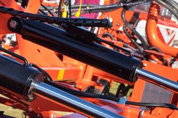 Fototapeta premium Black pistons or actuators in red pneumatic or hydraulic machine. Technology
