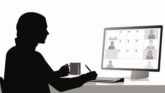 Silhouette of person attending a video conference with multiple participants on a computer screen at a desk