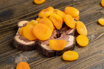 dried apricots are dehydrated after removing the seeds, apricots on a wooden board, close up, side view
