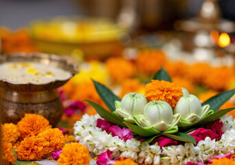 decorative floral arrangement with white lotus and marigold flowers for a festive celebration, symbolizing purity and devotion in spiritual rituals