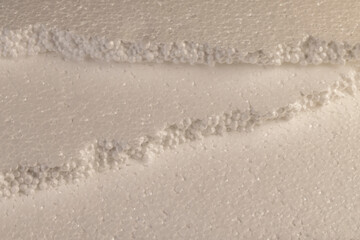 white foam made from a large number of pieces joined together, closeup, several pieces of material
