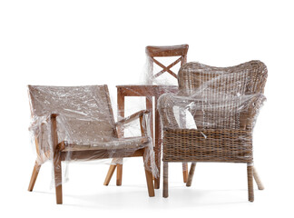 Chairs wrapped in stretch film on white background