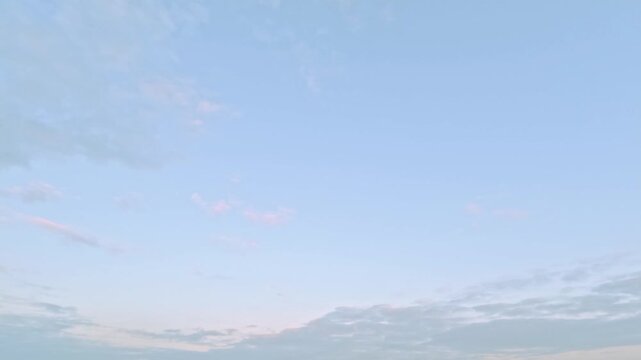 timelapse of the sky of beautiful light pink sundown clouds