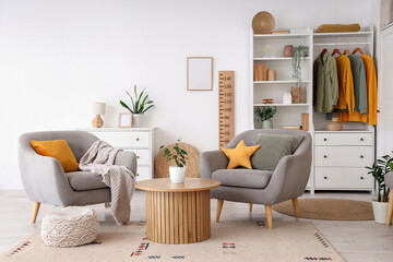 Interior of modern living room with armchairs, wardrobe, wooden stadiometer, coffee table and...