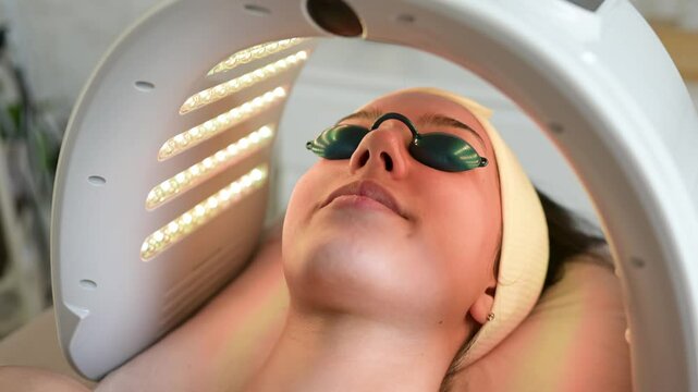 Woman undergoing hydrafacial LED light therapy treatment