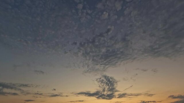fast timelapse of sunrise with rare fluffy clouds